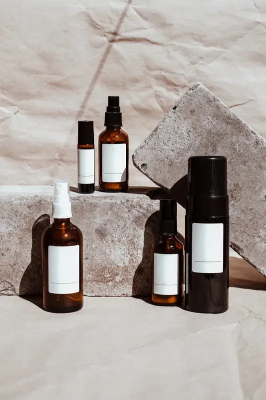 Amber skincare bottles on stone